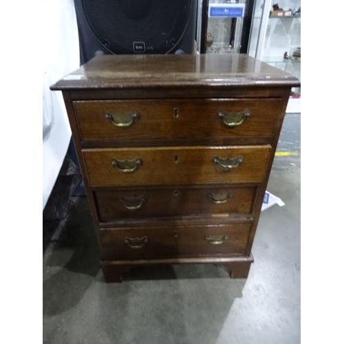 1176 - 20th century oak chest of four drawers, the top with applied moulded edge, brass handles and backpla... 