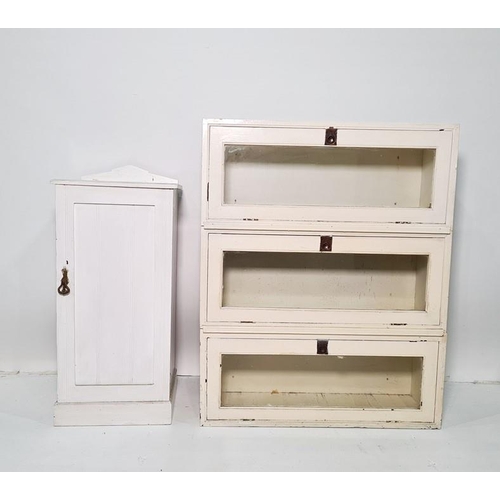 1179 - White painted sectional bookcase of three parts and a white painted pot cupboard (2)