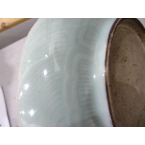 124 - Chinese porcelain shallow dish, celadon glaze with incised waves, 23cm diameter