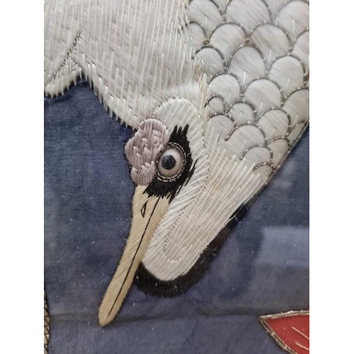 135 - Oriental embroidery
 Heron embroidered on blue silk ground, raised, with a glass(?) eye, leaves and ... 