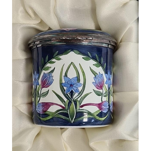 151 - Moorcroft enamel trinket pot, cylindrical with blue cornflower and crocus decoration on a white grou... 