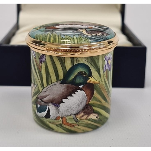 154 - Moorcroft enamel trinket pot, cylindrical and decorated with ducks and ducklings among bulrushes, in... 