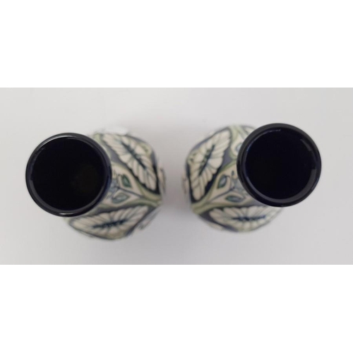 77 - Pair of Moorcroft pottery vases, each ovoid with slender neck, tube-lined decoration of convulvous a... 