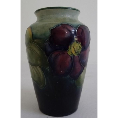 84 - Moorcroft pottery vase, shouldered and tapering, blue/green ground painted and tube-lined with clema... 