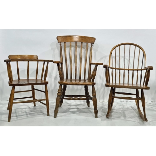 1401 - Elm seated captain's type chair, a modern comb-back rocking chair and one further armchair (3)