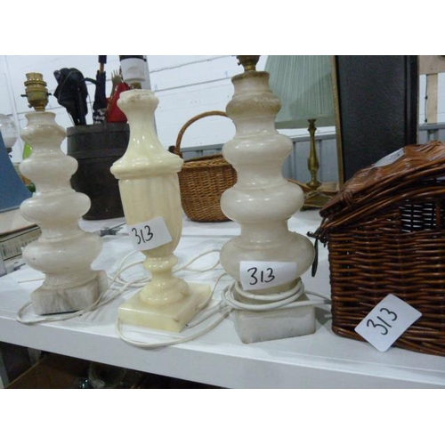 313 - Pair of alabaster table lamps, another single table lamp and a wickerwork picnic basket and a quanti... 