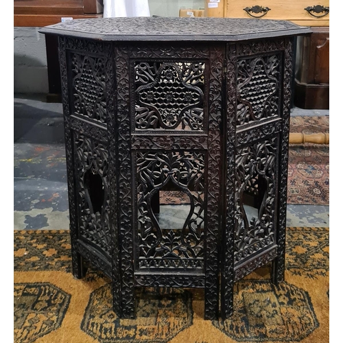 1354 - Anglo-Indian octagonal centre table with relief carved top with allover foliate decoration on foldin... 