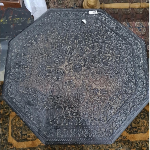 1354 - Anglo-Indian octagonal centre table with relief carved top with allover foliate decoration on foldin... 