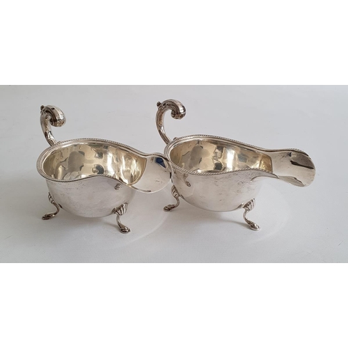 456 - Pair of Edward VIII silver sauce boats on splayed feet, with egg and dart decoration to rim, Birming... 