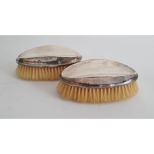 464 - Pair of early 20th century gentleman's silver-mounted oval hairbrushes, of plain form (some small de... 