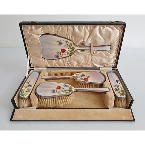 469 - 1930's silver and enamel mounted dressing set comprising of four brushes and mirror, cased, the pale... 