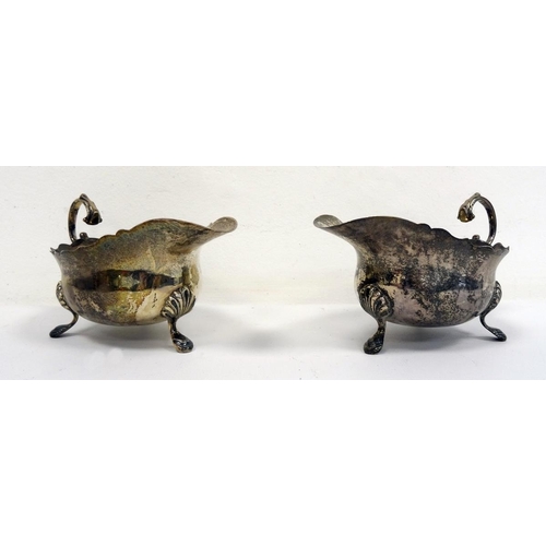 491 - Pair of 1920's silver sauceboats of plain form with scalloped feet, London 1929, maker's mark worn, ... 