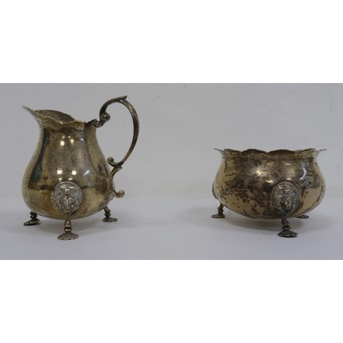 492 - 1920's Mappin & Webb silver milk jug and sugar bowl, both with mask decorated feet, London 1927, 6.9... 