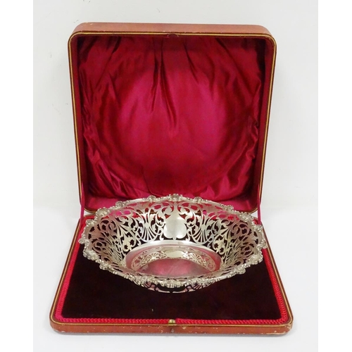 519 - Early 20th century silver bowl with pierced scroll rim, scalloped and scroll relief edges, in red le... 