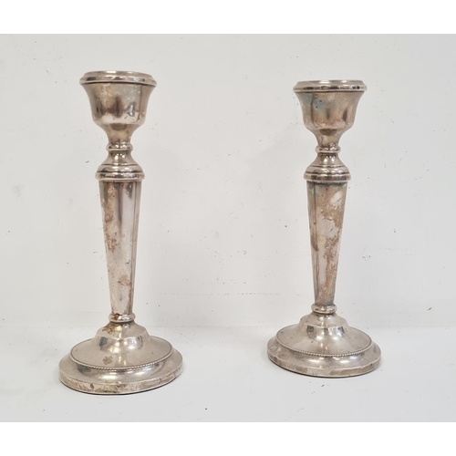 530D - A pair of 20th Century silver mounted candlesticks, tapering on circular bases, 19cm high