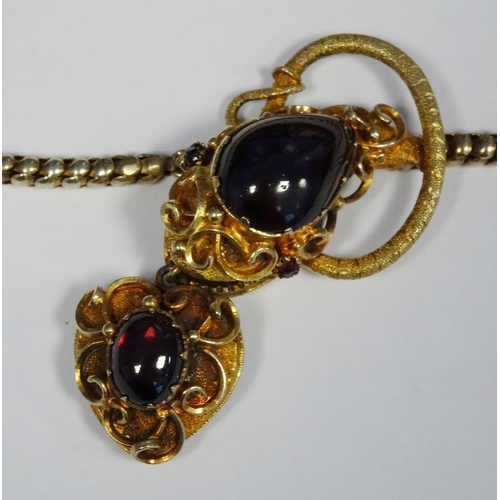 594 - Victorian gold-coloured metal and cabochon garnet necklace, the snake-pattern chain with ornate serp... 