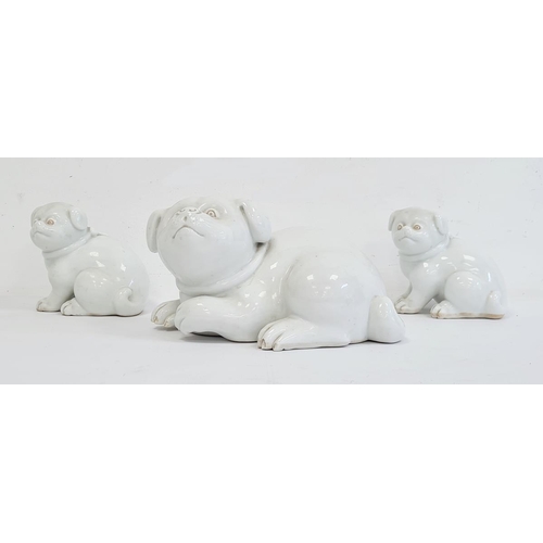 96a - Three Japanese Meiji period Hirado porcelain model of Akita puppies, each modelled in a seated posit... 