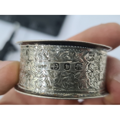 467A - Victorian silver napkin ring, Birmingham 1895 with ivy leaf engraving, a whale handled toddy ladle a... 