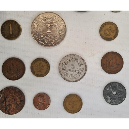 214 - An undated 20p coin and a small quantity of English and foreign coins in tin