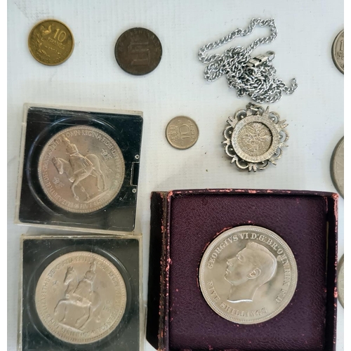 214 - An undated 20p coin and a small quantity of English and foreign coins in tin