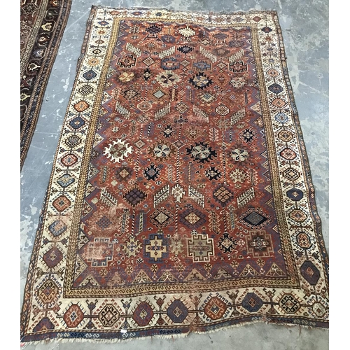 1350 - Red ground rug, possibly Persian, and possibly circa 1860, with allover hooked arabesques and medall... 