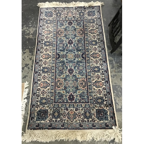 1355A - Turkish wool rug, the ivory ground with light blue rectangle to centre with allover medallions and a... 