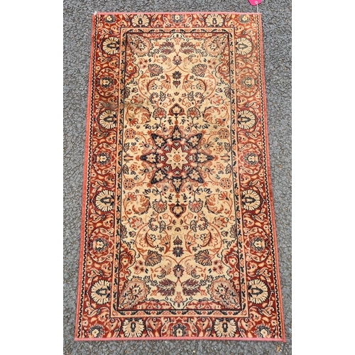 1357 - A modern  Persian style rug, cream ground,  central flower- shaped medallion, floral decorated in re... 