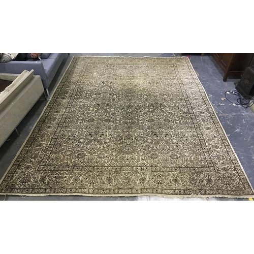 1361 - A large Persian style wool rug, yellow cream ground, all over brown floral decoration and border. Me... 