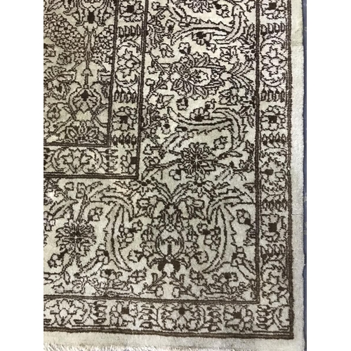 1361 - A large Persian style wool rug, yellow cream ground, all over brown floral decoration and border. Me... 