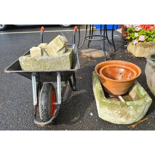 426 - Gardeners wheelbarrow containing D-end stone trough and four stone cornice pieces, another D-end sto... 