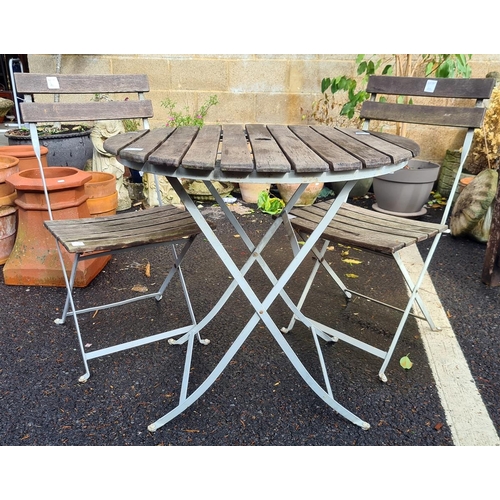 428 - Iron-framed and wooden-slatted top circular garden table, diameter 75cm with two matching folding ch... 