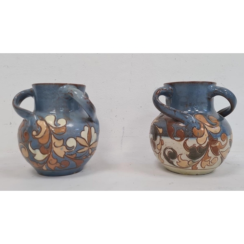 6A - Pair H Brannam Barum glazed terracotta three-handled vases, each foliate decorated on a blue ground,... 