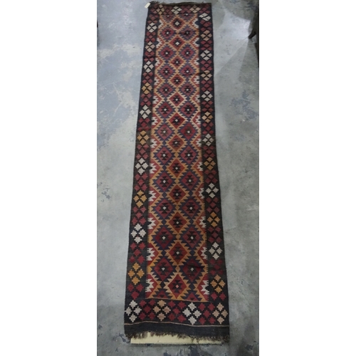 1365 - Eastern runner with repeating diamond-shaped tribal pattern, in reds, blues and peaches, thick borde... 