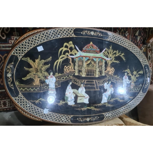 1318 - Modern Chinese style oval coffee table with nesting tables under, black ground and gilt decorated