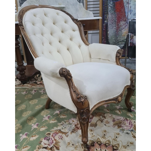 1346 - Victorian mahogany framed chair in a cream brown button back upholstery, carved exposed frame to cab... 