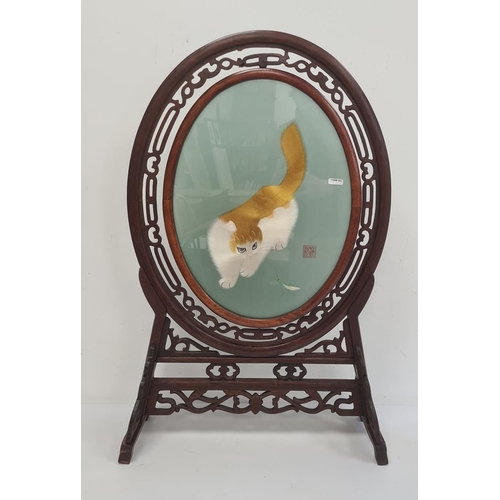 185 - Chinese hardwood oval frame on stand with pierced and carved decoration and with associated reversib... 