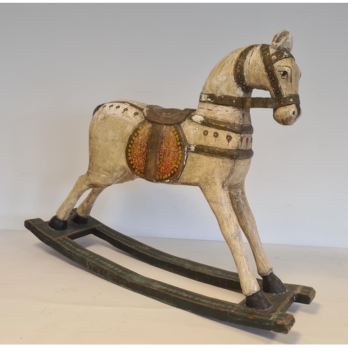 533 - Painted wooden rocking horse, the white horse with  saddle and bridle on green highlighted rocker