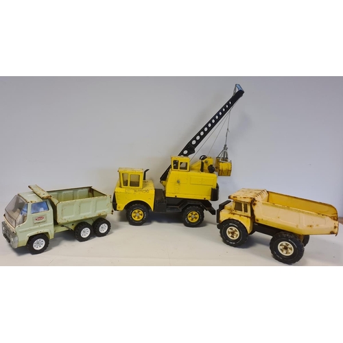 544 - Three Tonka Matchbox large trucks and crane, together with leather case with further tonka toys and ... 