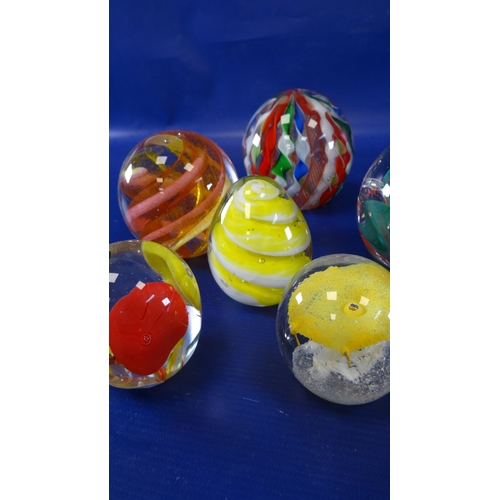 105 - Assorted glass paperweights to include Caithness 'Cauldron', Caithness 'Pebble', Caithness 'Cascadia... 