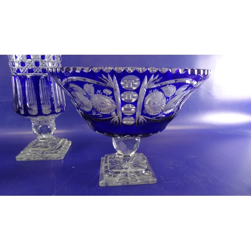 120 - Pair of blue glass pedestal bowls of circular form with flash cut floral decoration, on stepped squa... 