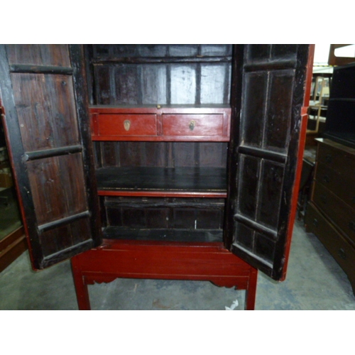 1128 - 20th century red lacquer Chinese marriage chest, the two doors enclosing shelves and two drawers, on... 