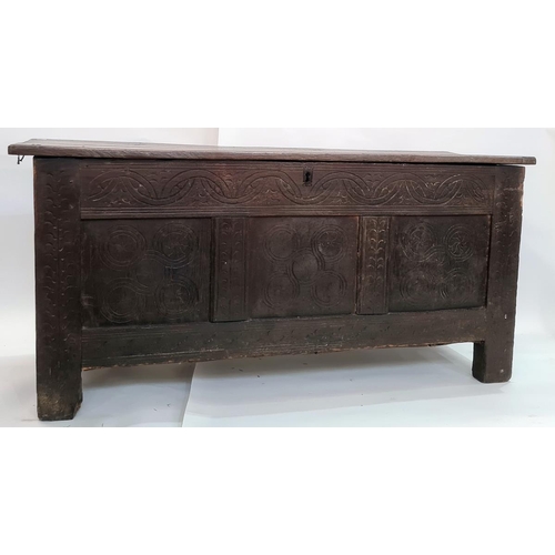 10 - Late 18th/early 19th century oak coffer, the plain top above carved front panels, on stile supports