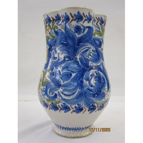 122 - Italian faience jug decorated with scrolling flowers in a blue, green, yellow and orange palette, 25... 