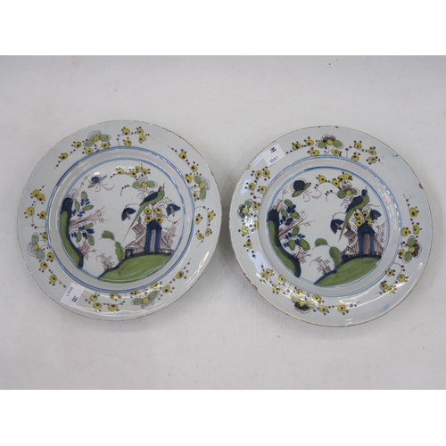 136 - Pair of English delft plates, Liverpool circa 1760, decorated with exotic birds in floral landscape,... 