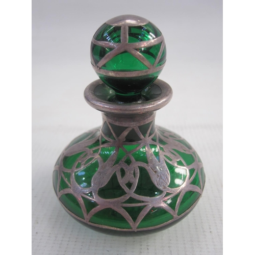 144 - Silver-coloured metal mounted green glass miniature scent bottle having spherical stopper, the squat... 