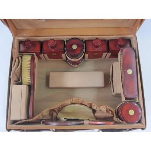 166 - Circa 1930's leather vanity case opening to a leather interior, enclosing red lacquer and inlaid gil... 