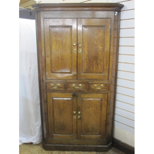 36 - 18th century oak standing corner cupboard with cavetto cornice, upper section enclosed by pair field... 