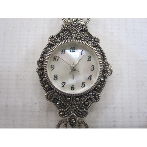 495 - Modern lady's bracelet watch with circular mother-of-pearl dial in marcasite case and on pierced mar... 