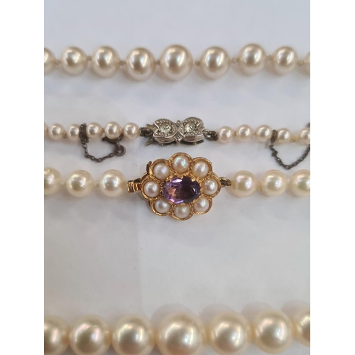 551 - Graduated row of cultured pearls with 9ct gold clasp set with an oval mix-cut amethyst surrounded by... 