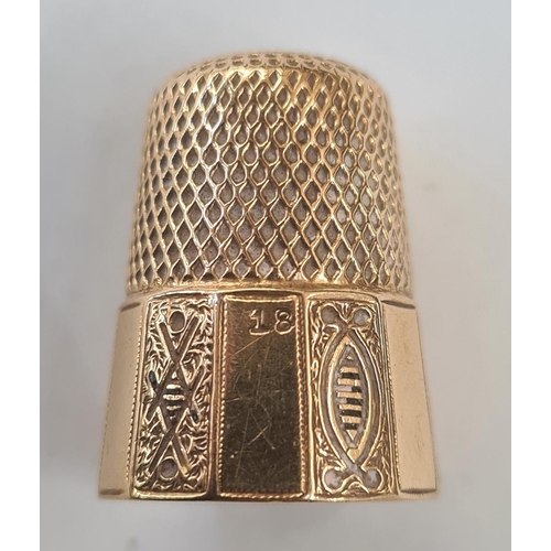 563 - 18ct gold thimble with panelled and floral decoration, 7.4g approx